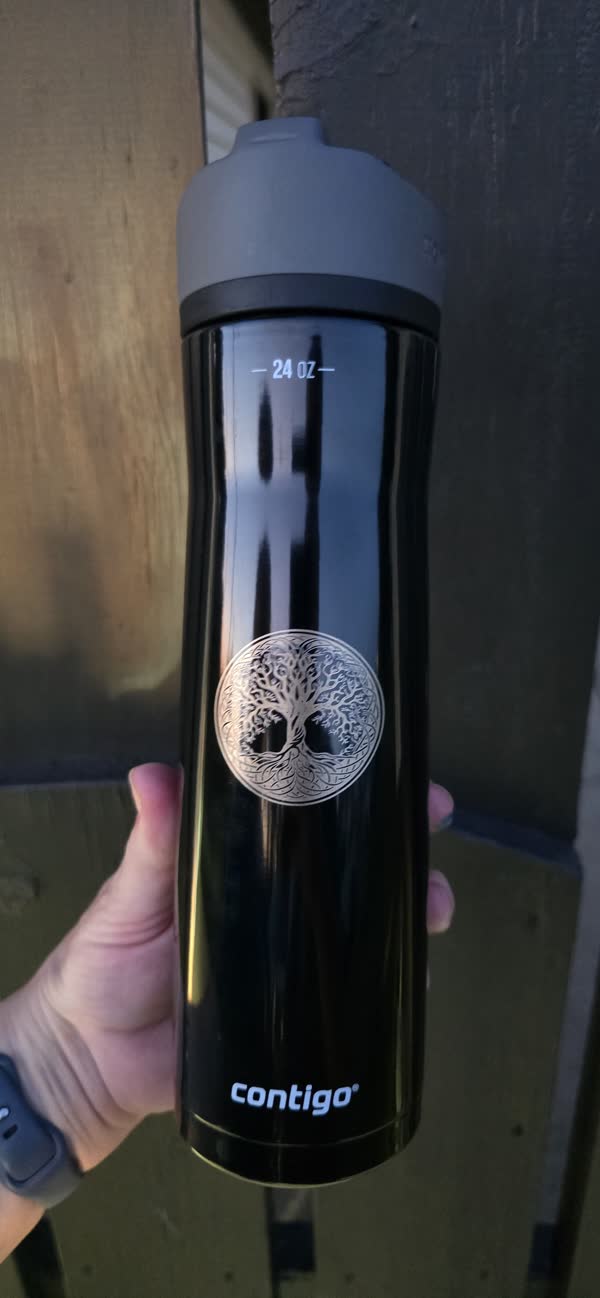 Customer’s own black travel bottle engraved with a circular tree of life design